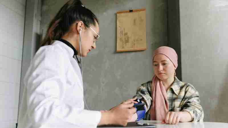 A medical professional checks a patient's blood pressure, depicting a caring healthcare environment., tags: sonnet biotherapeutics studie - pexel